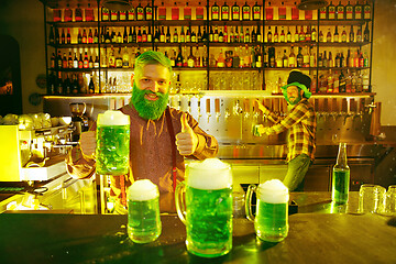 Image showing Happy man with glass of beer looking aside in pub