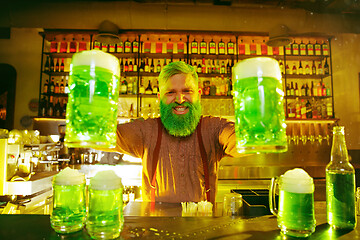 Image showing Happy man with glass of beer looking aside in pub