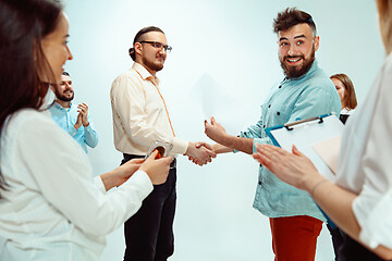 Image showing Boss approving and congratulating young successful employee