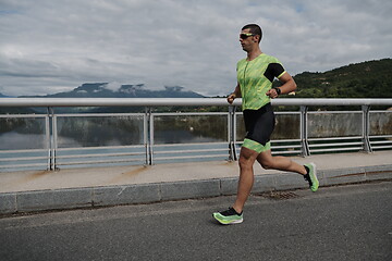 Image showing triathlon athlete running on street