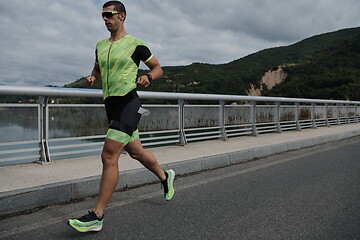 Image showing triathlon athlete running on street