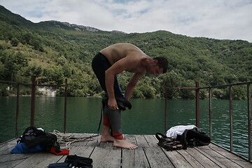 Image showing triathlon athlete getting ready for swimming training on lake