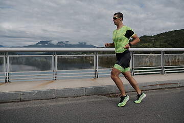 Image showing triathlon athlete running on street