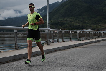 Image showing triathlon athlete running on street