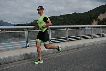 Image showing triathlon athlete running on street