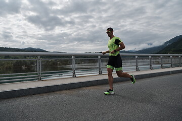 Image showing triathlon athlete running on street