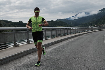 Image showing triathlon athlete running on street