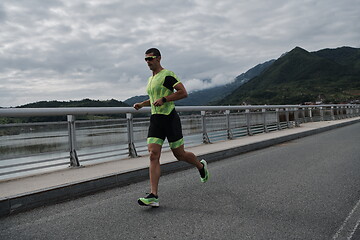 Image showing triathlon athlete running on street