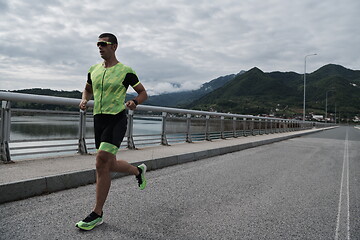 Image showing triathlon athlete running on street