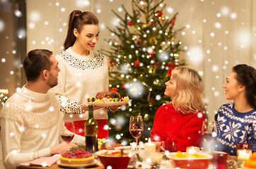 Image showing happy friends having christmas dinner at home