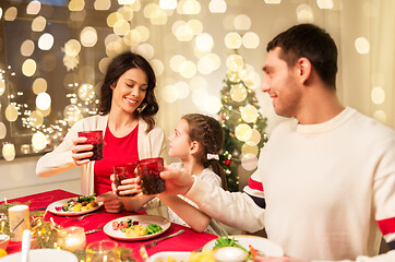 Image showing happy family having christmas dinner at home