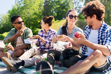 Image showing happy friends having picnic at summer park