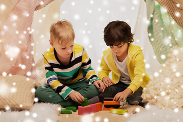 Image showing boys playing toy blocks in kids tent at home