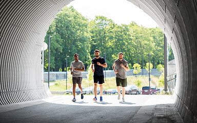 Image showing young men or male friends running outdoors