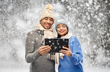 Image showing couple in winter clothes with tablet computer