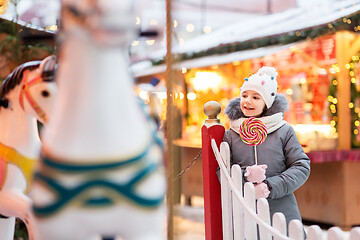 Image showing girl with lollipop at christmas market