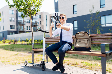 Image showing businessman taking selfie and showing thumbs up