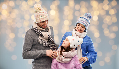 Image showing family in winter clothes over christmas lights