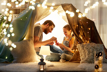 Image showing family playing tea party in kids tent at home