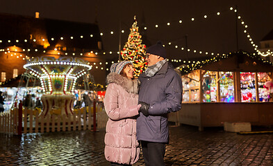 Image showing happy senior couple hugging at christmas market