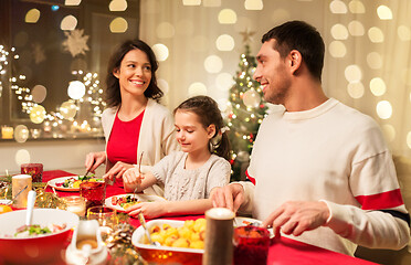 Image showing happy family having christmas dinner at home