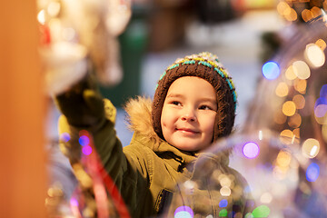 Image showing happy little boy at christmas market in winter