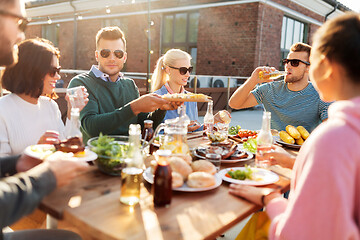 Image showing friends having dinner or bbq party on rooftop