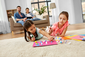 Image showing happy sisters doing arts and crafts at home