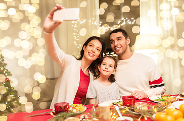 Image showing happy family taking selfie at christmas dinner