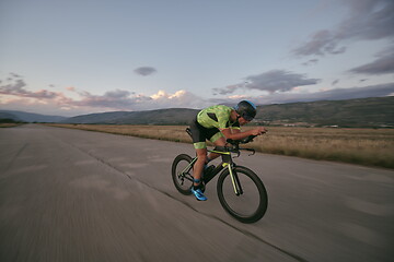 Image showing triathlon athlete riding a bike