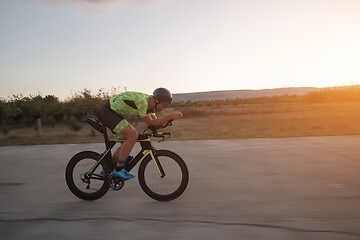 Image showing triathlon athlete riding a bike