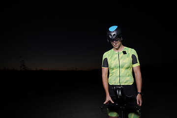 Image showing triathlon athlete portrait while resting on bike training