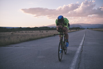 Image showing triathlon athlete riding a bike