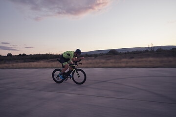 Image showing triathlon athlete riding a bike