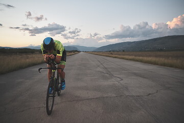 Image showing triathlon athlete riding a bike