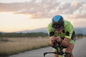 Image showing triathlon athlete riding a bike