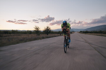 Image showing triathlon athlete riding a bike