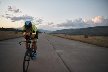 Image showing triathlon athlete riding a bike