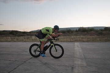 Image showing triathlon athlete riding a bike