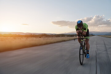 Image showing triathlon athlete riding a bike