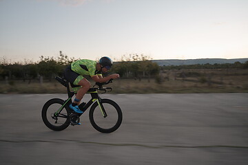 Image showing triathlon athlete riding a bike