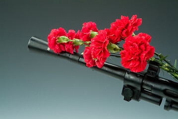 Image showing Machine Gun And Flowers