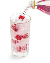 Image showing pink soft drink pouring into glass