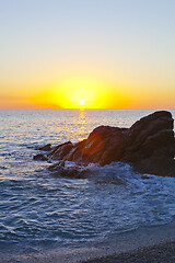 Image showing Sunset on the rocky shore.