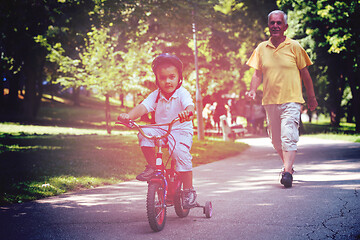 Image showing grandfather and child have fun  in park