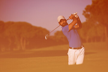 Image showing pro golfer hitting a sand bunker shot