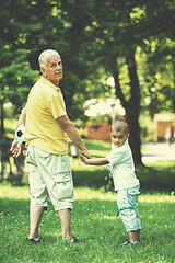 Image showing grandfather and child have fun  in park