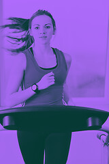 Image showing womanworkout  in fitness club on running track machine