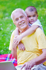 Image showing grandfather and child using laptop