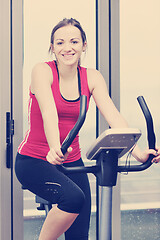 Image showing womanworkout  in fitness club on running track machine